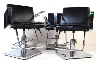 FOUR CONTEMPORARY BLACK VINYL SALON BARBER CHAIRS / ARMCHAIRS