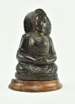 WOODEN CARVED FIGURINE OF A SEATED BUDDHA ON A PLINTH