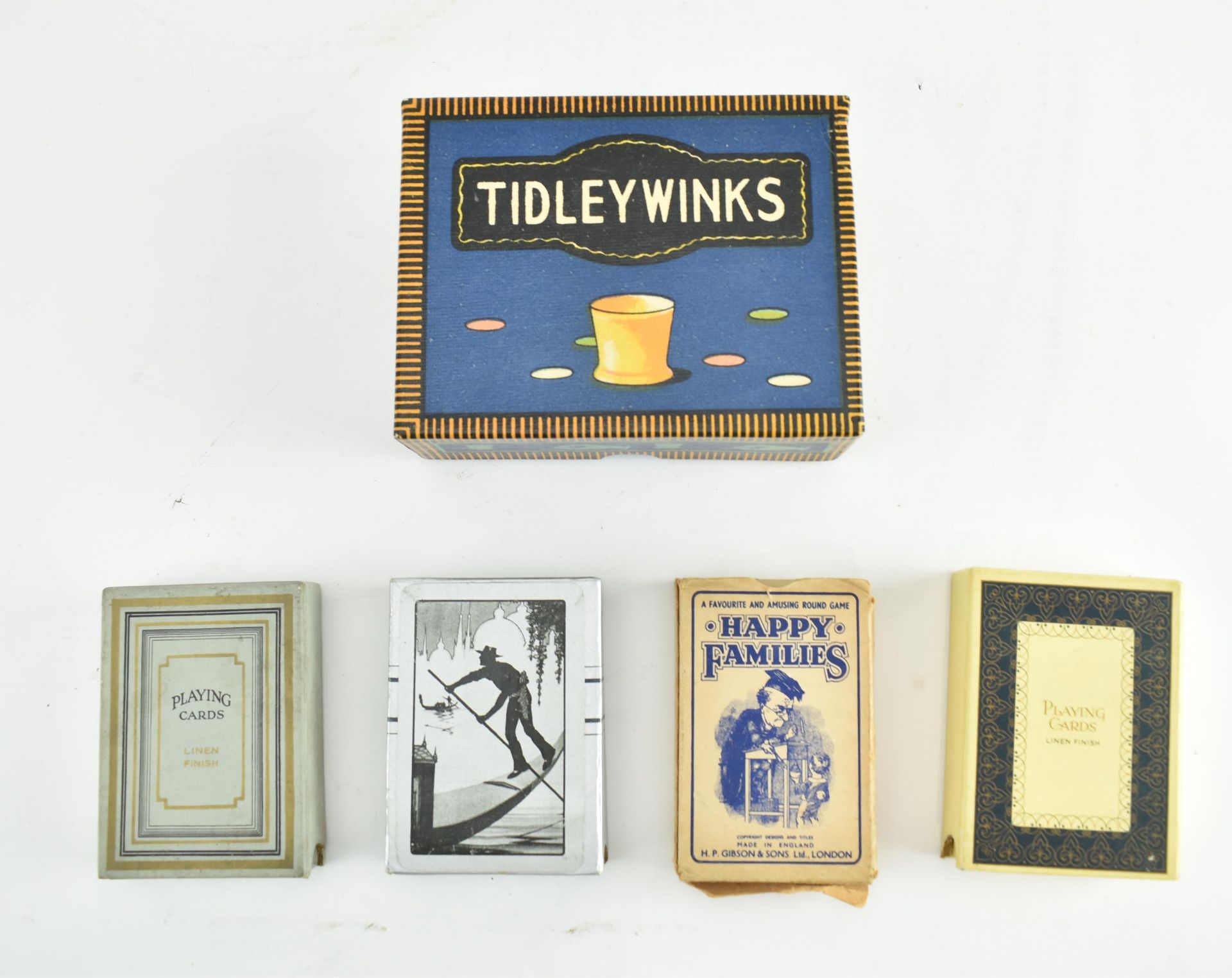 COLLECTION OF FOUR PLAYING CARDS AND A TIDLEY WINKS SET