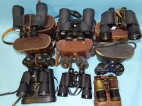 A collection of nine pairs of binoculars: Canon 7x50 no.25521, Zenith Zoom 7x-12x40, Swift Belmont