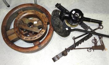 Two iron pot hangers, a hanging balance scale and two French polished wood pulley wheels, one with