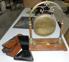 A brass gong on stand, with beater, and other items.