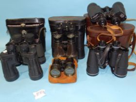 A collection of seven pairs of binoculars, including Dollond 10x50 Field, Hilkinson 10x50 Field,