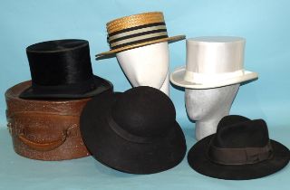 A straw boater, a top hat (worn), a white satin top hat and two felt hats, (5).