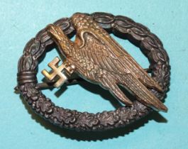 A WWII Third Reich Nazi Luftwaffe Paratrooper badge in white and gilt metal, reverse impressed G H
