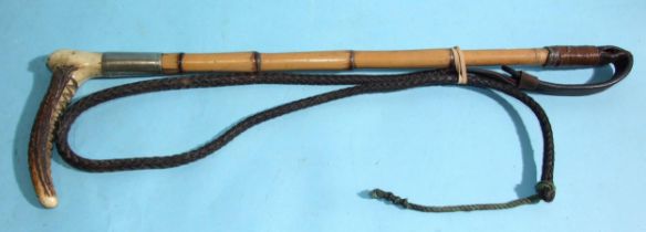 An early-20th century hunting whip with bamboo and stag antler handle and plaited leather lash,