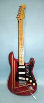 A similar guitar, with striped metallic red and black body, made in Mexico, no.MN4150556.