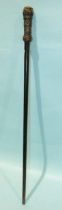 A lacquered hardwood cane with woven rope knot handle, 83cm long.