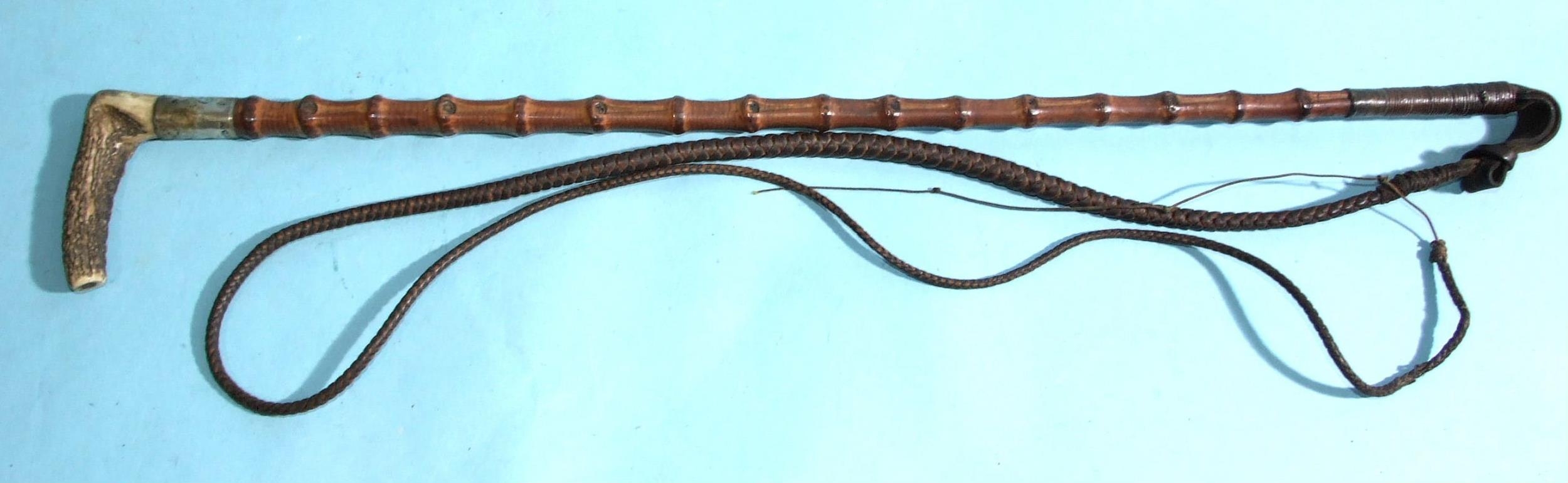 A flexible bamboo hunting whip with antler handle, silver collar and plaited lash, shaft 69cm,