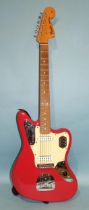 A Fender Jaguar, made in Mexico, with pink and cream body, no.MX18001423.