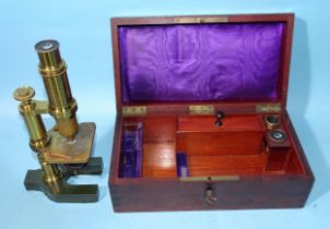 A brass lacquered unnamed microscope on metal Y-shaped base, 25cm high, in fitted mahogany box.