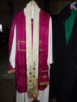 A collection of ecclesiastical vestments and clerical robes.