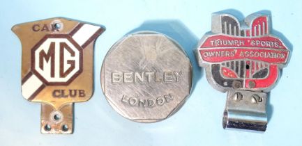 An "MG Car Club" badge, a "Triumph Sports Owners Association" badge and a "Bentley, London" hub dust