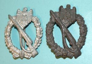 A German Army Waffen SS Infantry Assault Badge in silver-grade pressed metal and another, diecast