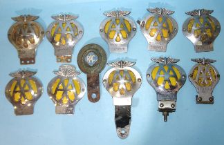 A collection of AA badges: five "Must be Returned" to front, three "Property of ..." stamped to