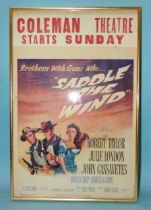 A 1957 film poster "Brothers With Guns Who Saddle The Wind", framed with Coleman Theatre banner,