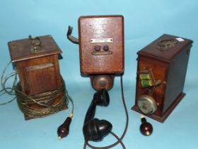 A wall-mounted telephone with bell and Bakelite hand set and two mahogany cased electric bells.