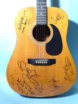 Oasis, a Hohner model MW-400G acoustic guitar with signatures of Noel Gallagher with message "To