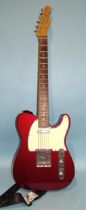 A Fender Telecaster, made in Mexico, with metallic red and cream body, no.MX14468249.