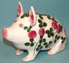 A Bovey Tracey Plichta pottery pig decorated with pink clover, 28cm long, 20cm high.