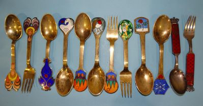 A collection of ten Danish silver gilt and enamel year spoons and forks, all signed with different