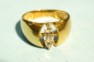 An 18ct yellow gold ring claw-set three synthetic white stones, size M½, 4.7g.