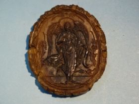 A Russian amber medallion impressed with an archangel to each side, 5.2 x 4.5cm.