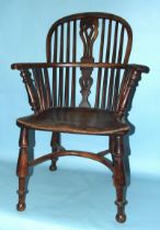 A 19th century yew wood and elm-seated Windsor chair with solid seat, on turned legs with