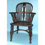 A 19th century yew wood and elm-seated Windsor chair with solid seat, on turned legs with