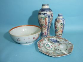 An 18th century Chinese famille rose vase decorated with figures in a landscape, a similar smaller