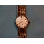 Omega, a lady's 9ct gold wrist watch, the circular silvered face (18mm) with baton numerals, on