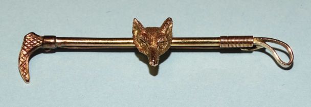 A 9ct gold fox mask and riding crop brooch, 2.9g, 5cm, (boxed).