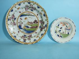 An 18th century Dutch Delft charger and a smaller similar plate, (2).