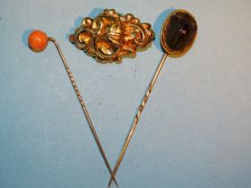 A Victorian brooch of leaf form, (tests as 18ct gold approximately), 4g, a Victorian stick pin set