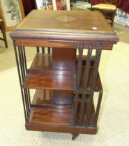 An Edwardian inlaid mahogany revolving bookcase, 52cm square, 87cm high, (some damage to struts).