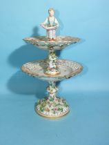 A 19th century Meissen porcelain two-tier comport surmounted with a female gardener, (chipping to