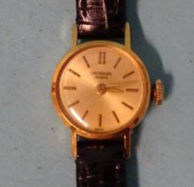 Universal Genève, a lady's 18ct gold manual wrist watch on leather strap, (winds and runs).