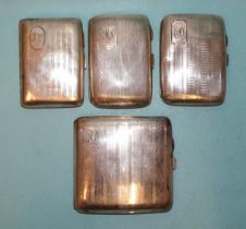 A collection of four silver engine-turned cigarette cases, various dates, all with monograms,