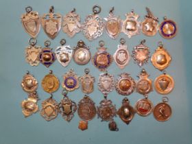 A collection of thirty-three silver medallions, some inset gold, including a cricket medallion for