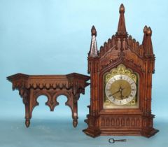 A late-19th/early-20th century oak bracket clock, the architectural Gothic case enclosing a gong-