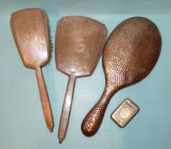 An engine-turned silver-backed hand mirror and clothes brush, (marks rubbed), another silver-