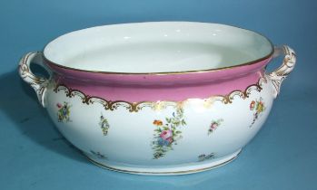 An oval foot bath painted with flowerheads and gilt detail on a puce border, 53cm wide, printed mark