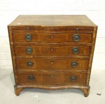 A George III mahogany crossbanded and inlaid serpentine chest, the quarter-veneered top above a