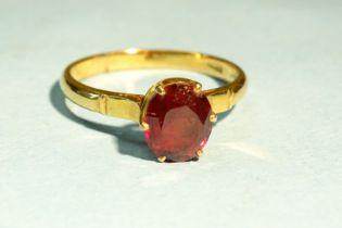 A gold ring claw-set an oval garnet, bearing Chinese gold marks, size N, 3.4g.