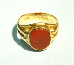 An 18ct yellow gold signet ring with ribbed shank and carnelian intaglio, (plain), size Q, 8.3g.