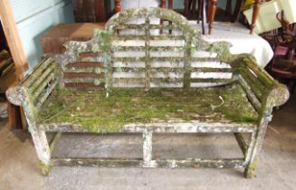 A teak garden bench adorned with mosses and lichen, 164cm wide.