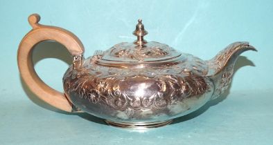 A Georgian silver teapot of squat form with embossed floral and leaf decoration, 10cm high, (marks