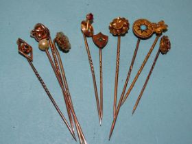 Ten various 9ct, 15ct and 18ct gold topped stickpins, 12.6g.