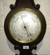 A Negretti and Zambra aneroid wheel barometer and thermometer in oak case, 93cm high.