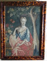 A late-18th/19th century needlework and collage picture of a young woman seated by an oak tree, with